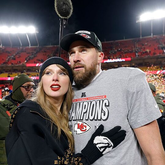 Taylor Swift celebrates with Travis Kelce #87 of the Kansas City Chiefs after defeating the Buffalo Bills