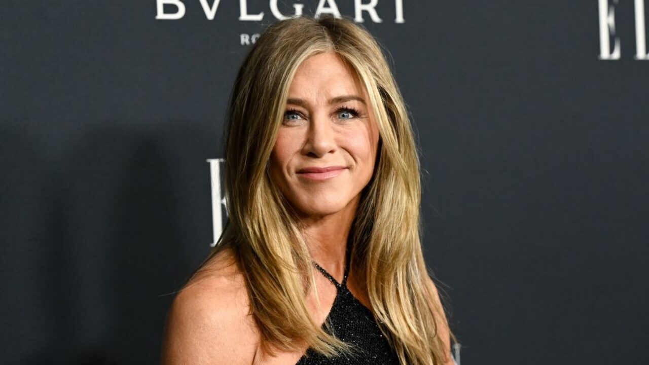 Jennifer Aniston smiling in halterneck dress
