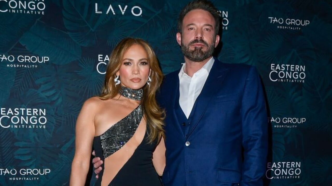 photo of jennifer lopez and ben affleck with arms around each other on red carpet