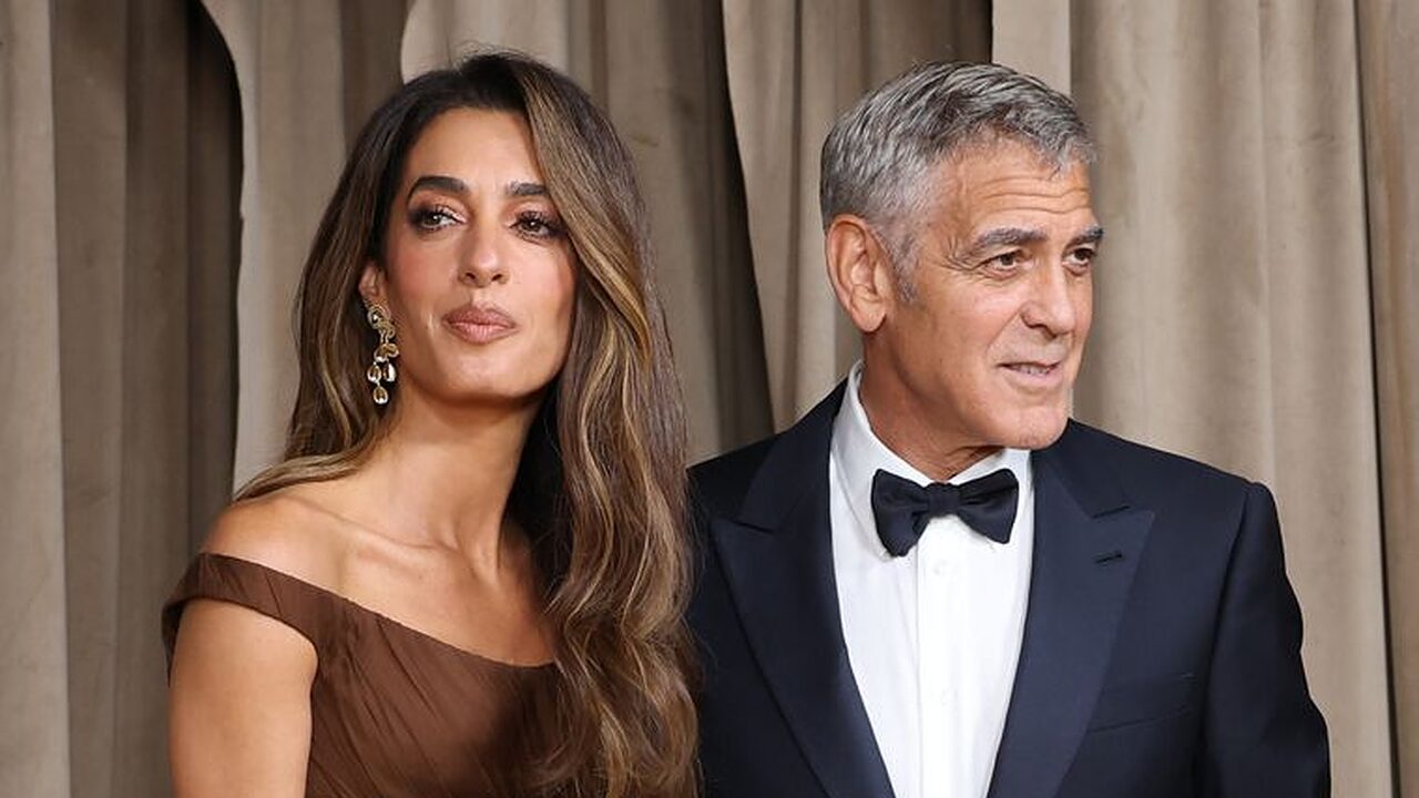 photo of amal clooney in brown dress beside george clooney in black suit