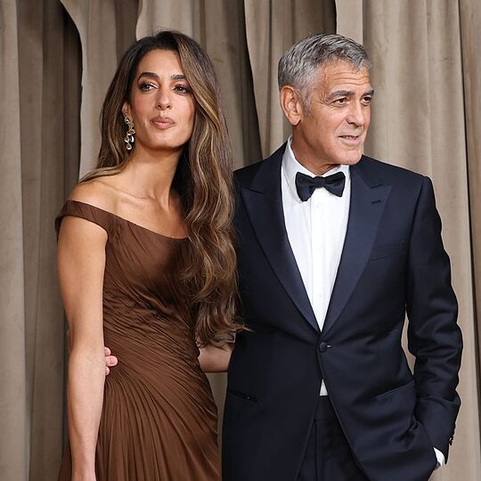 photo of amal clooney in brown dress beside george clooney in black suit