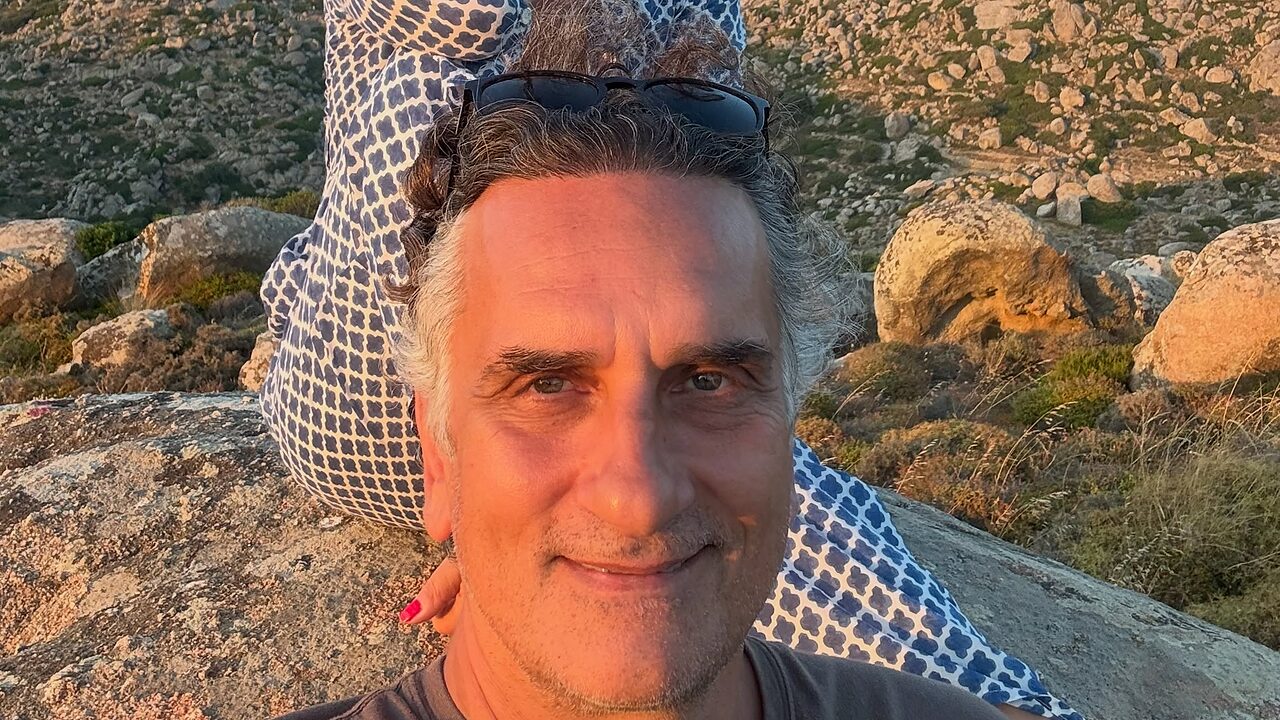 Το ερωτευμένο ζευγάρι απολαμβάνει το κυκλαδίτικο τοπίο και τη θάλασσα του Αιγαίου.